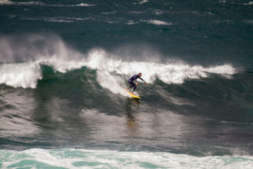 Unknown surfer taming stormy Pantin.