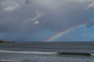 Unicorn rainbow surfing in Razo, Galicia.